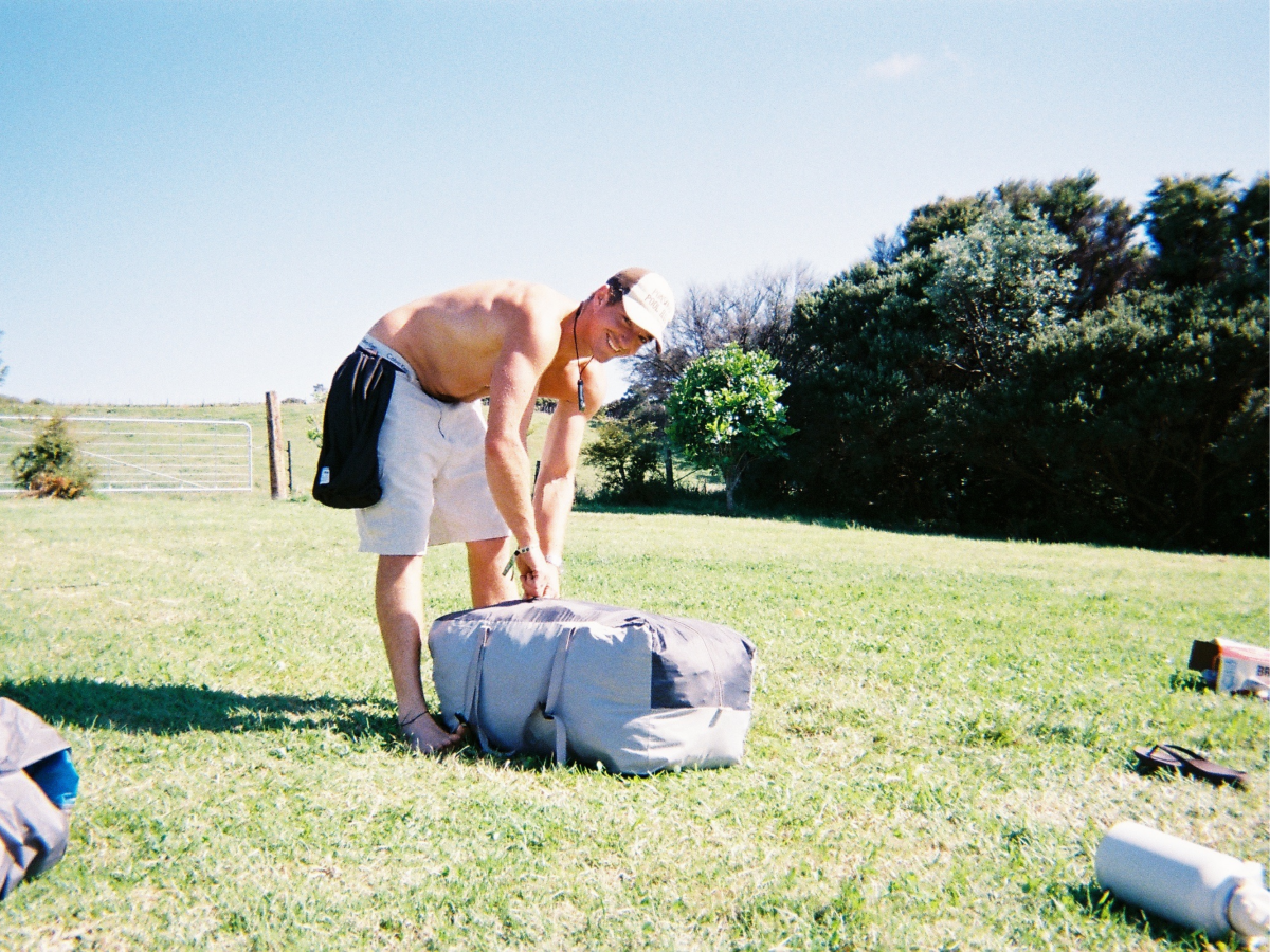 Attendee setting up their campsite at Matakanarama in the sunshine
